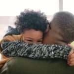 httpscdn.britannica.com59223259-050-5FC11D2ELittle-boy-hugging-father-parent-child.jpg