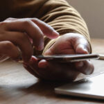 header-manPhoneLaptop