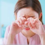 Asian woman WFH suffering from eye strain presbyopia myopia