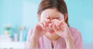Asian woman WFH suffering from eye strain presbyopia myopia