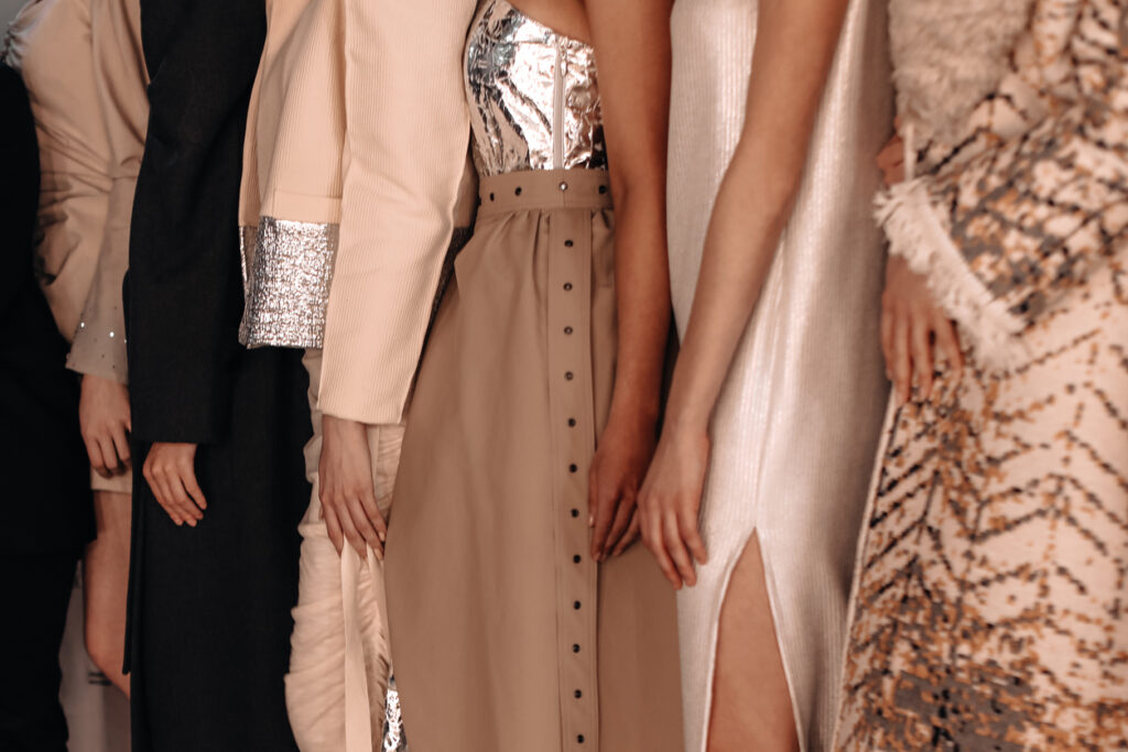 Women dressed in beige outfits dresses and skirts, fashion collection of women's elegant clothes