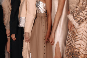 Women dressed in beige outfits dresses and skirts, fashion collection of women's elegant clothes